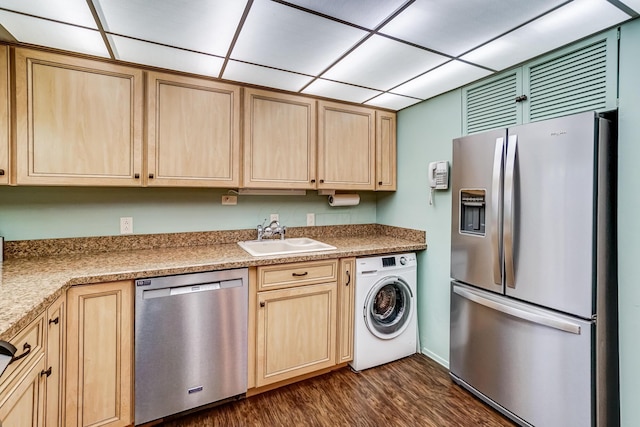 kitchen featuring light brown cabinets, sink, stainless steel appliances, and washer / clothes dryer