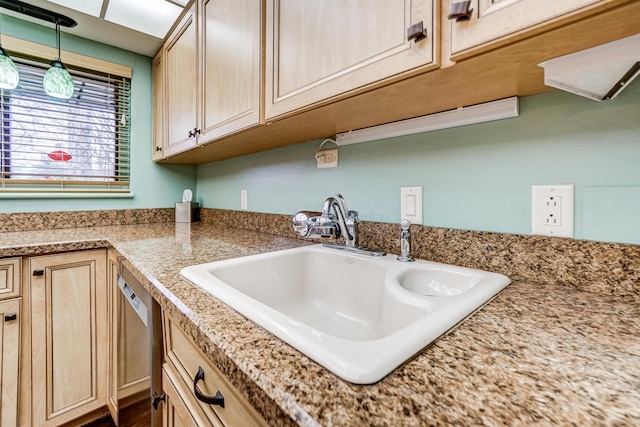 kitchen with pendant lighting, dishwasher, sink, and light brown cabinetry