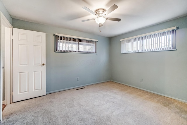 unfurnished room featuring ceiling fan and light colored carpet