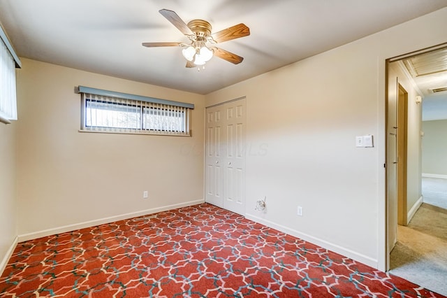 unfurnished bedroom with carpet floors, a closet, and ceiling fan