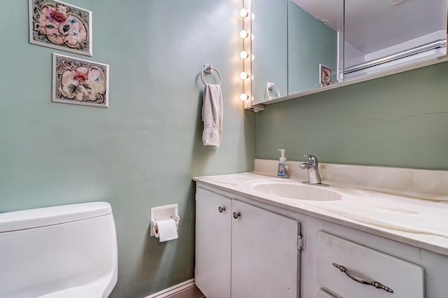 bathroom featuring vanity and toilet