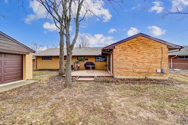 rear view of property featuring a patio and an outdoor structure