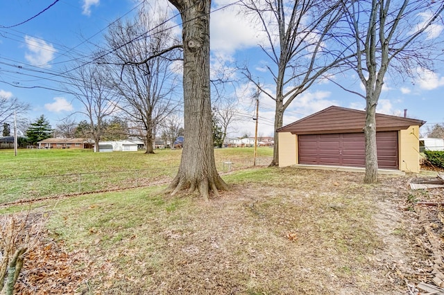 view of yard featuring an outdoor structure and a garage