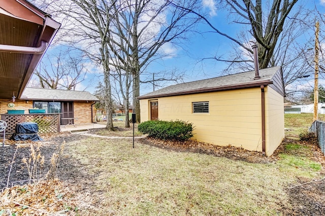 view of side of home with a yard