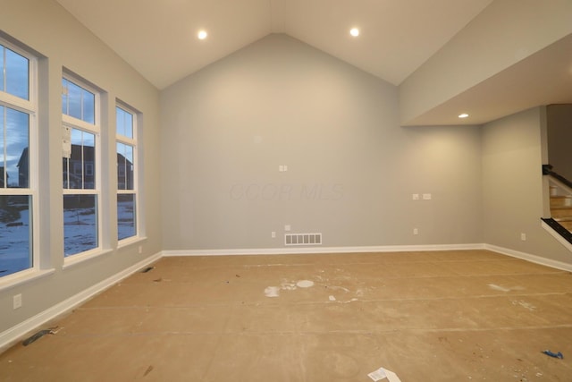 empty room featuring lofted ceiling