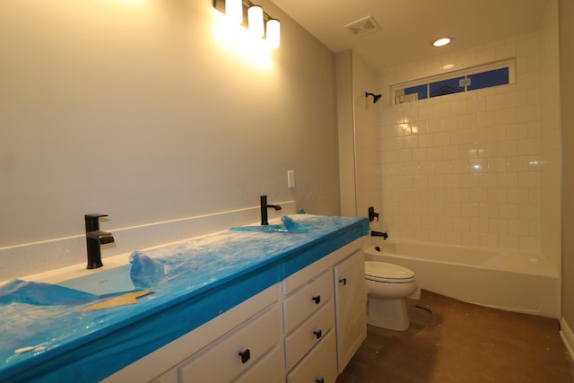 full bathroom with tiled shower / bath combo, vanity, and toilet