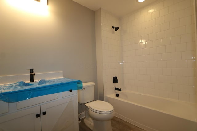 full bathroom with tiled shower / bath, vanity, and toilet