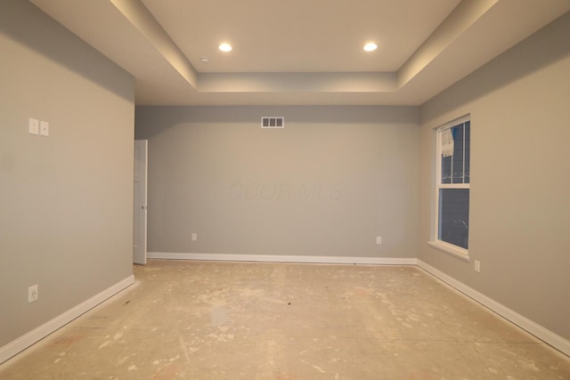 empty room with a tray ceiling