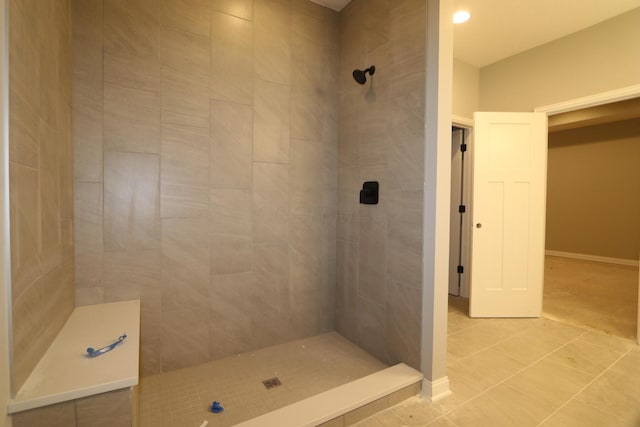 bathroom featuring tile patterned flooring and tiled shower