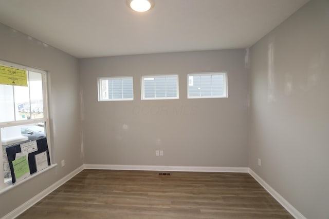 spare room with dark wood-type flooring