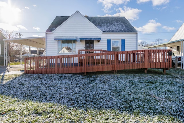 rear view of property featuring a carport and a wooden deck