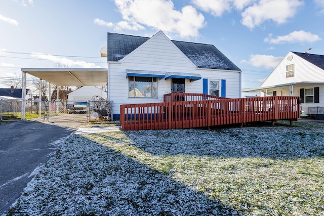 back of house featuring a carport and a wooden deck