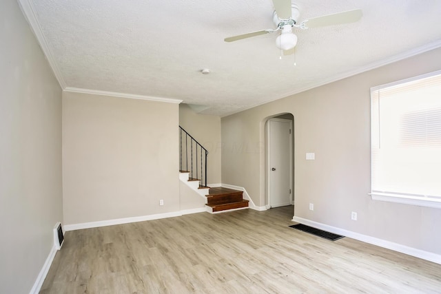 unfurnished room featuring ceiling fan, crown molding, a textured ceiling, and light wood-type flooring