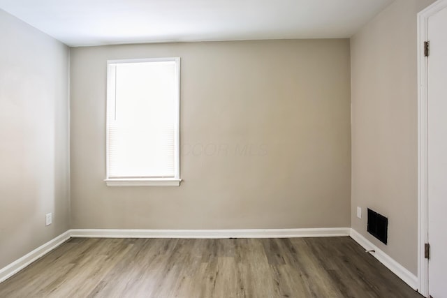 spare room featuring hardwood / wood-style flooring