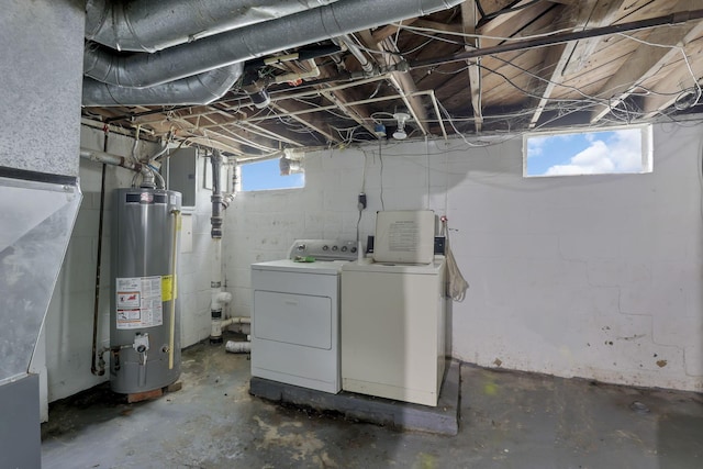 basement featuring gas water heater and washing machine and dryer