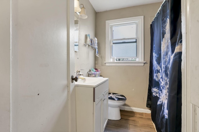 bathroom featuring vanity, toilet, and wood-type flooring