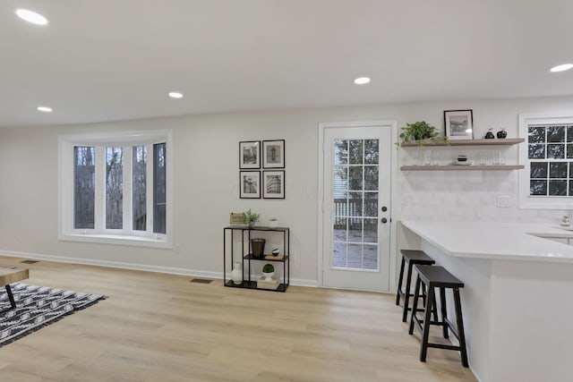 interior space featuring a wealth of natural light and light hardwood / wood-style flooring