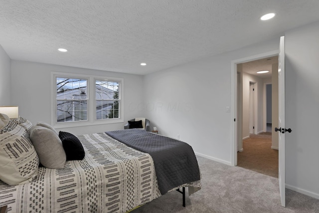 carpeted bedroom featuring a textured ceiling