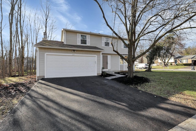 view of front of home with a front lawn and a garage