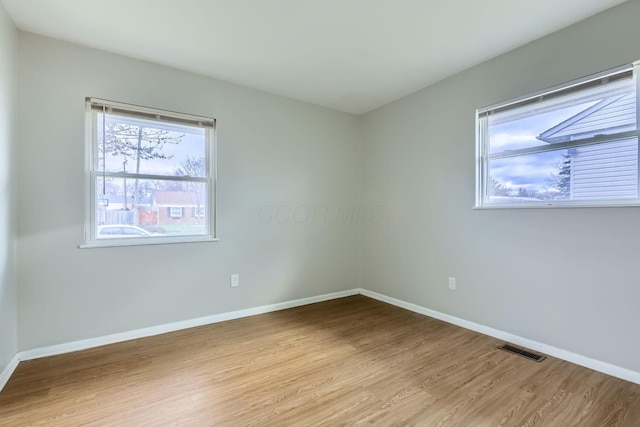 spare room featuring light wood-type flooring