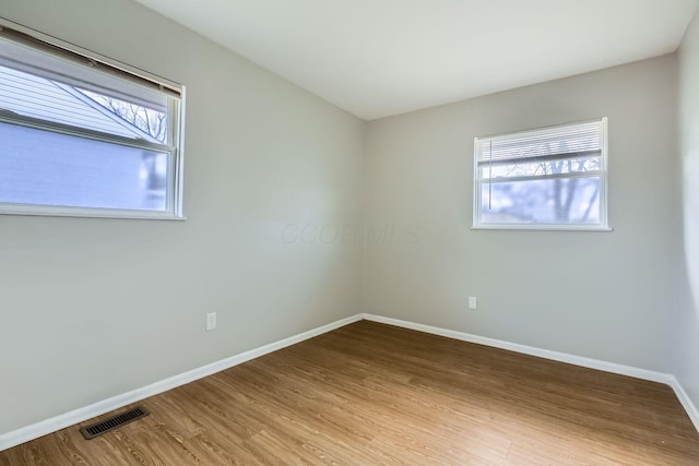 unfurnished room featuring light hardwood / wood-style flooring and plenty of natural light