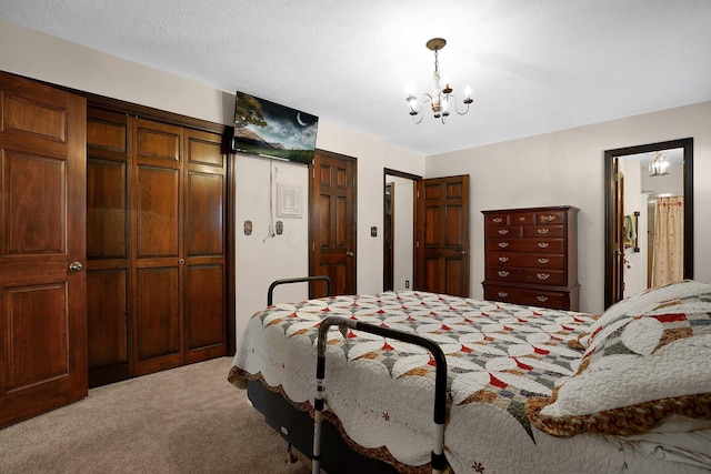 carpeted bedroom featuring a notable chandelier