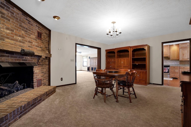 dining room with light carpet, a brick fireplace, an inviting chandelier, and a textured ceiling