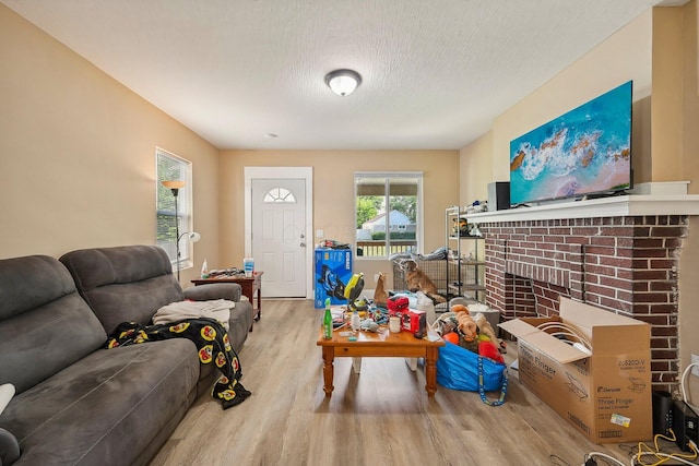 living room with a textured ceiling and light hardwood / wood-style flooring