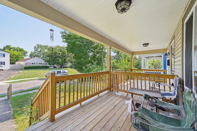 wooden terrace featuring covered porch