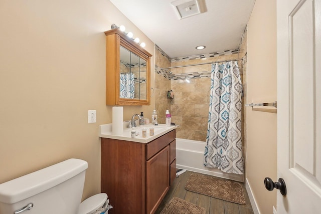 full bathroom featuring hardwood / wood-style floors, vanity, toilet, and shower / bath combo