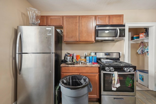 kitchen featuring stainless steel appliances and wood-type flooring