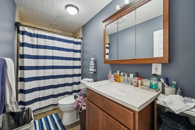 bathroom with curtained shower, a textured ceiling, toilet, vanity, and hardwood / wood-style flooring