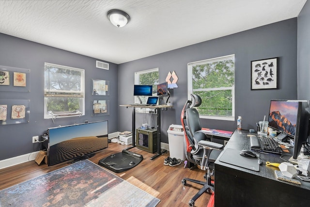 office featuring wood-type flooring and a textured ceiling