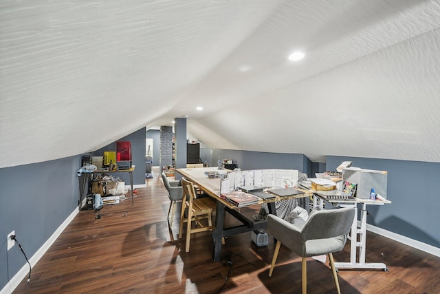 dining space with vaulted ceiling and dark wood-type flooring