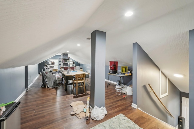 interior space featuring dark wood-type flooring and vaulted ceiling