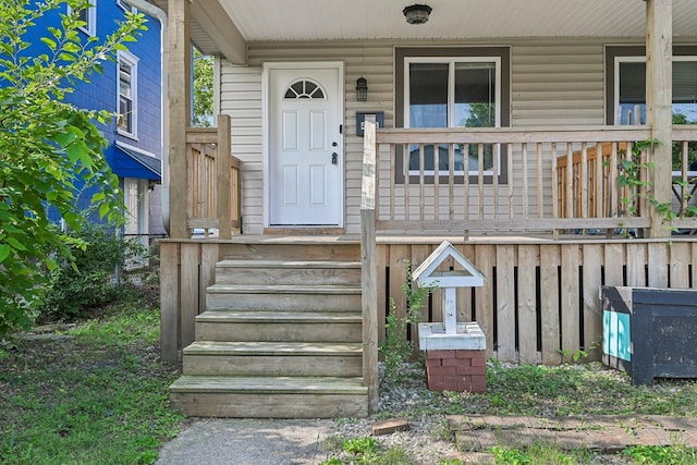 view of exterior entry featuring a porch