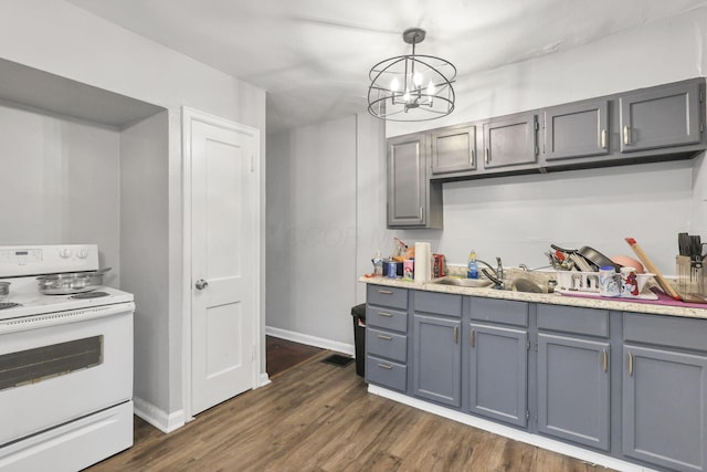 kitchen with pendant lighting, an inviting chandelier, electric stove, dark hardwood / wood-style floors, and gray cabinets