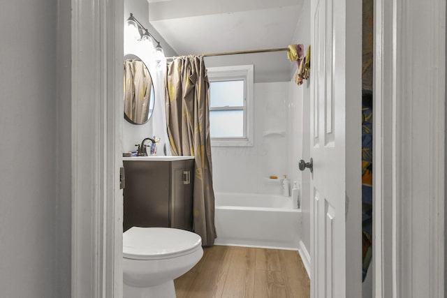 full bathroom featuring vanity, wood-type flooring, shower / tub combo, and toilet