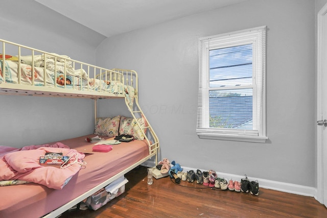 bedroom with dark hardwood / wood-style flooring