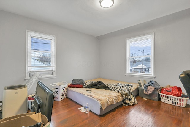 bedroom with dark hardwood / wood-style floors