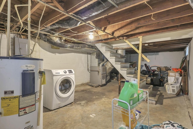 basement featuring washer / dryer, heating unit, and water heater