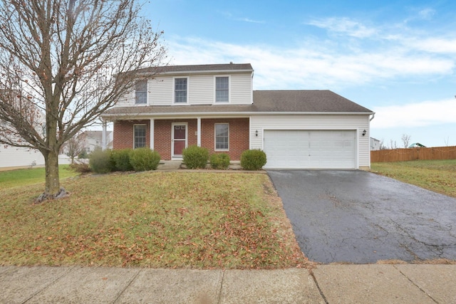 front of property featuring a front lawn, a porch, and a garage