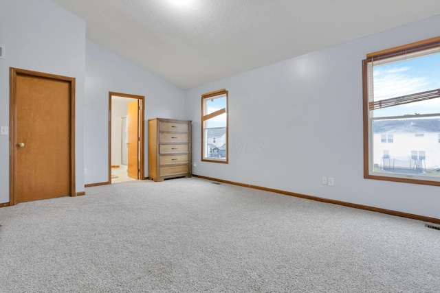 unfurnished bedroom with light carpet and vaulted ceiling