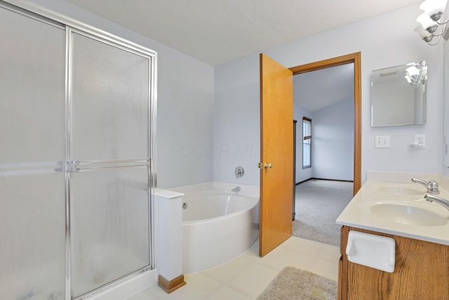 bathroom featuring vanity, a textured ceiling, and independent shower and bath