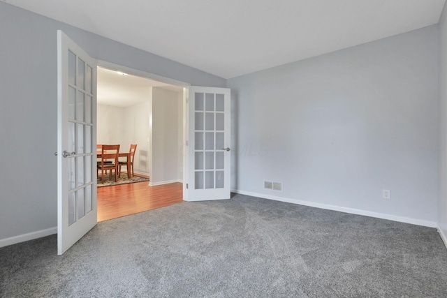 carpeted empty room featuring french doors