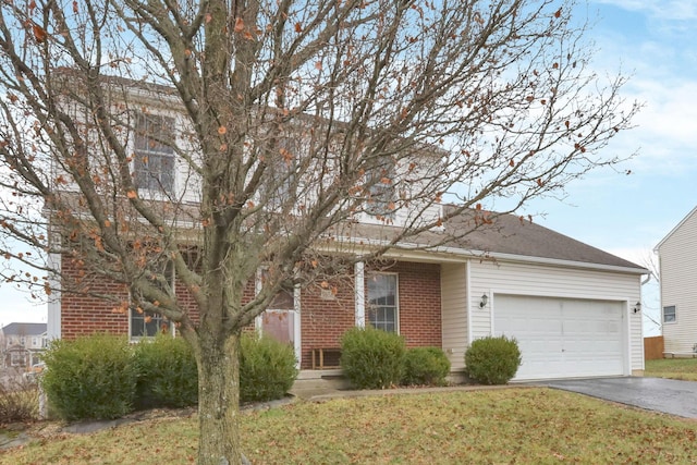 view of front of property with a front yard and a garage