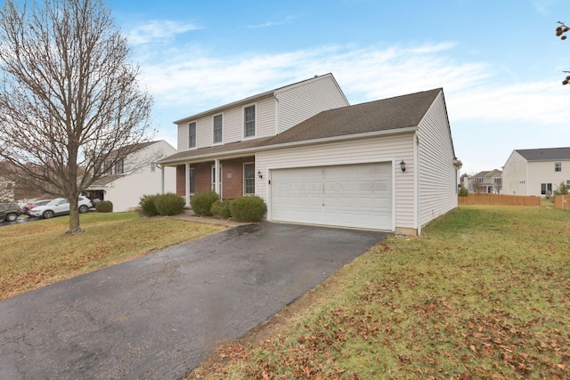 view of property featuring a front lawn and a garage