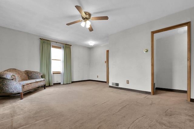 interior space featuring light carpet and ceiling fan