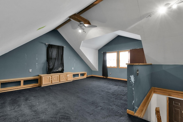 bonus room with ceiling fan, dark carpet, and vaulted ceiling