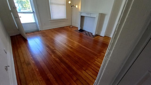 unfurnished living room with wood-type flooring